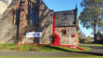 The church with a fall of poppies around the porch